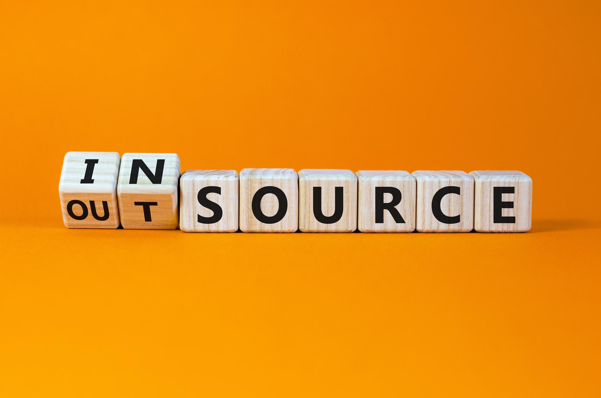 Holzwürfel zeigen Wahl zwischen Insource und Outsource | Essen Reinigungsfirma